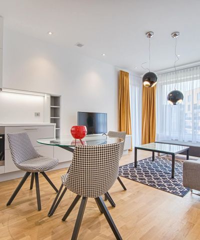 two chairs with glass table on living room near window